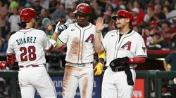 Eugenio Suarez #28 of the Arizona Diamondbacks celebrates with Geraldo Perdomo #2 and Josh Naylor #22 after hitting a three run home run.