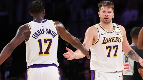Luka Doncic #77 and Dorian Finney-Smith #17 of the Los Angeles Lakers slap hands in the second half against the Phoenix Suns at Crypto.com Arena on March 16, 2025 in Los Angeles, California.