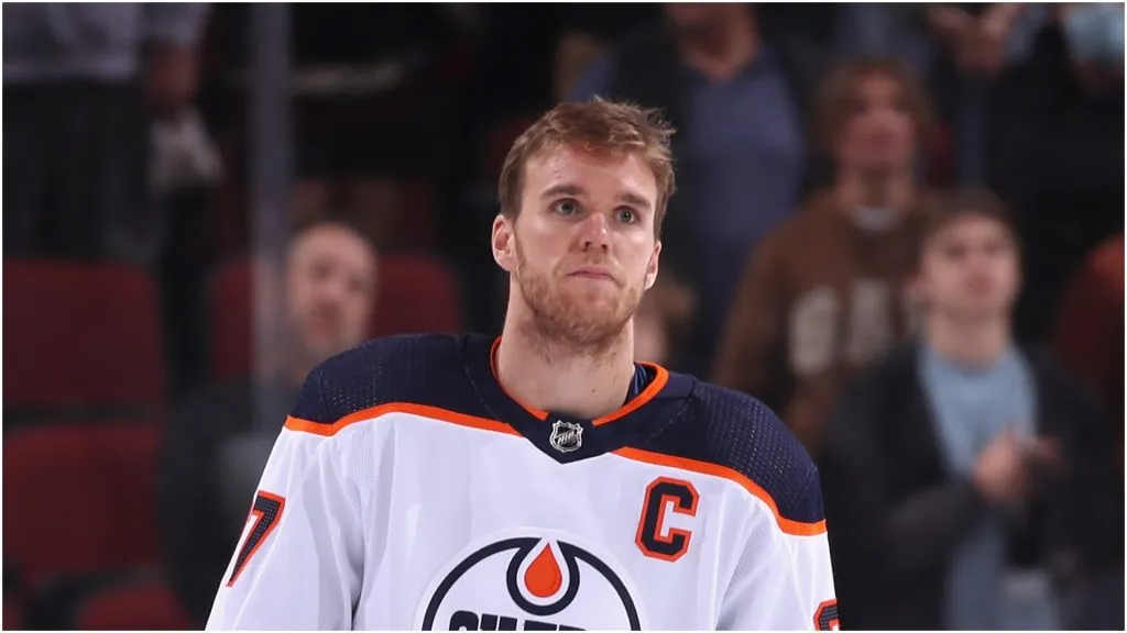 Connor McDavid #97 of the Edmonton Oilers stands attended for the Canadien national anthem before the NHL game against the Arizona Coyotes at Gila River Arena on November 24, 2021 in Glendale, Arizona.