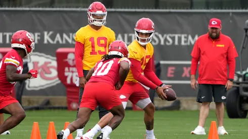 Patrick Mahomes #15 of the Kansas City Chiefs hands the ball of to Isiah Pacheco #10 during drills at The University of Kansas Health System Training Complex on June 18, 2025.