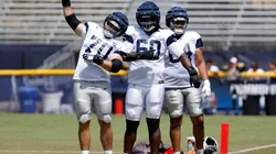Guard Zack Martin #70 offensive tackle Tyler Guyton #60 and offensive tackle Earl Bostick Jr. #64 of the Dallas Cowboys stretch during training camp on July 30, 2024.