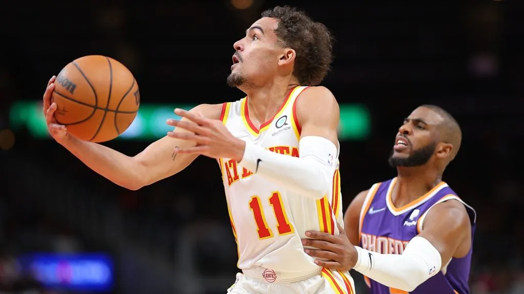 Trae Young of the Atlanta Hawks drives past Chris Paul of the Phoenix Suns on February 03, 2022.