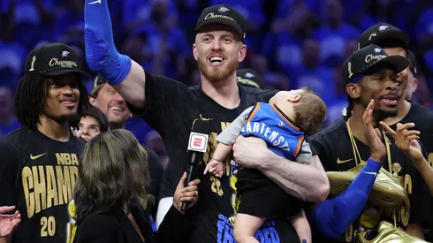 Isaiah Hartenstein #55 of the Oklahoma City Thunder celebrates with his son Elijah after defeating the Indiana Pacers 103-91 in Game Seven of the 2025 NBA Finals.