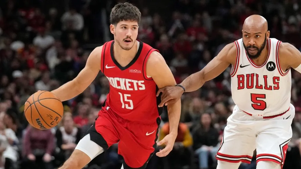 Reed Sheppard #15 of the Houston Rockets dribbles the ball against Jevon Carter #5 of the Chicago Bulls during the third quarter at the United Center on November 17, 2024. (Source: Patrick McDermott/Getty Images)