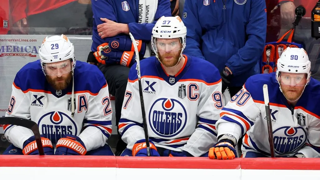 Leon Draisaitl #29, Connor McDavid #97, and Corey Perry #90 with the Edmonton Oilers react from the bench during the third period against the Florida Panthers in Game Six of the 2025 Stanley Cup Final at Amerant Bank Arena on June 17, 2025 in Sunrise, Florida. (Photo by Mike Carlson/Getty Images)