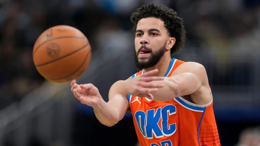 Ajay Mitchell #25 of the Oklahoma City Thunder passes the ball during the first half of an NBA basketball game against the Indiana Pacers at Gainbridge Fieldhouse on December 26, 2024. (Source: Jeff Dean/Getty Images)