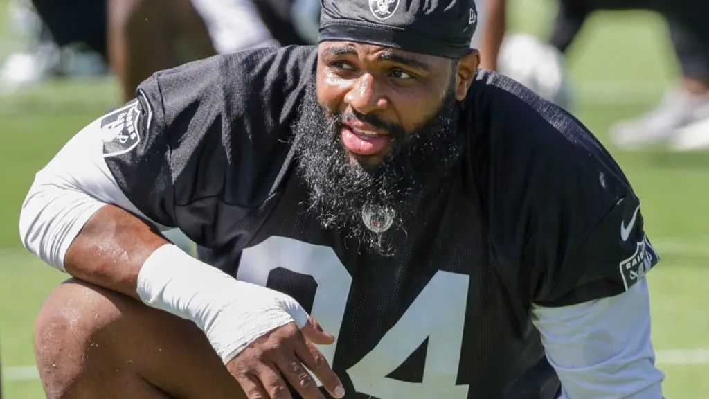 HENDERSON, NEVADA – MAY 29: Defensive tackle Christian Wilkins #94 of the Las Vegas Raiders stretches during an OTA offseason workout at the Las Vegas Raiders Headquarters/Intermountain Healthcare Performance Center on May 29, 2024 in Henderson, Nevada. (Photo by Ethan Miller/Getty Images)