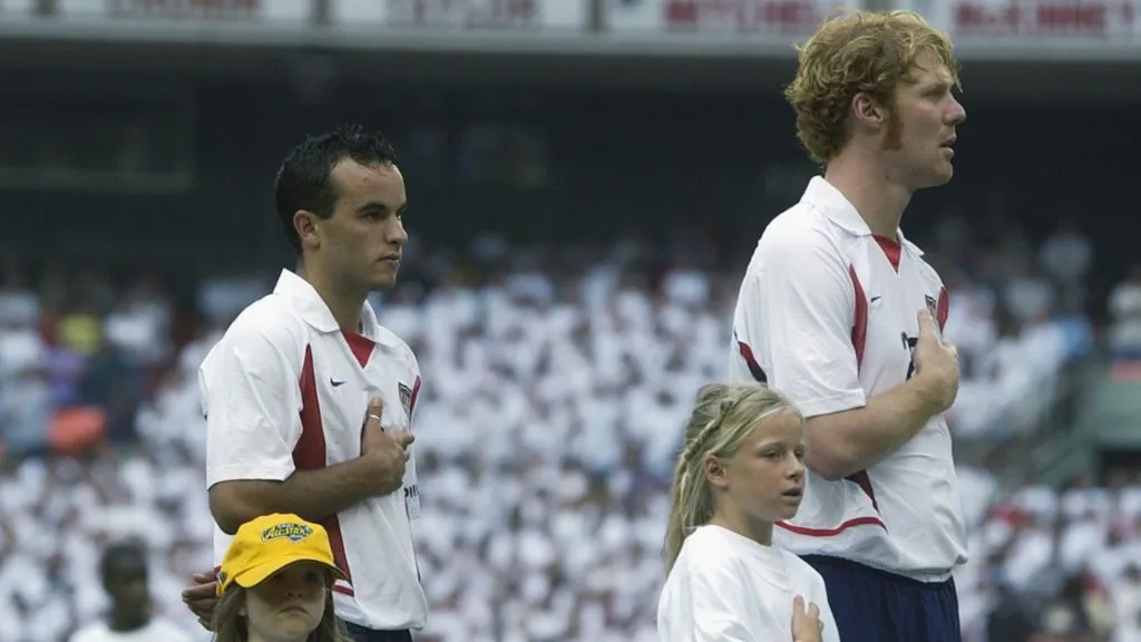 Landon Donovan and Alexi Lalas of the US National Team stand for the National Anthem before the MLS All Star match against the MLS All Star Team on August 3, 2002.