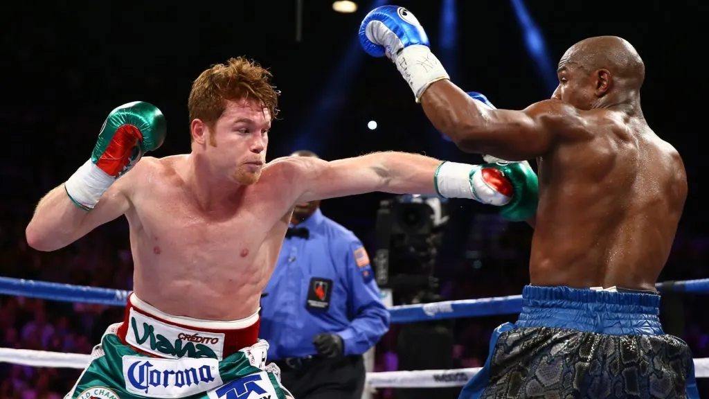 (L-R) Canelo Alvarez throws a left at Floyd Mayweather Jr. during their WBC/WBA 154-pound title fight at the MGM Grand Garden Arena on September 14, 2013 in Las Vegas, Nevada. (Photo by Al Bello/Getty Images)