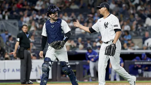 The New York Yankees celebrate the end of the first inning against the Toronto Blue Jays.