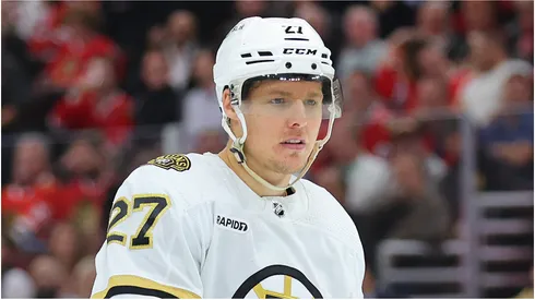 Hampus Lindholm #27 of the Boston Bruins looks on against the Chicago Blackhawks during the first period at the United Center on October 24, 2023 in Chicago, Illinois.