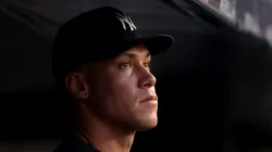 Injured Aaron Judge #99 of the New York Yankees stands in the dugout during their game against the Tampa Bay Rays at Yankee Stadium on July 28, 2025 in New York City.