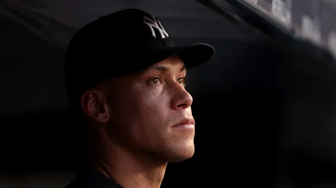 Injured Aaron Judge #99 of the New York Yankees stands in the dugout during their game against the Tampa Bay Rays at Yankee Stadium on July 28, 2025 in New York City.