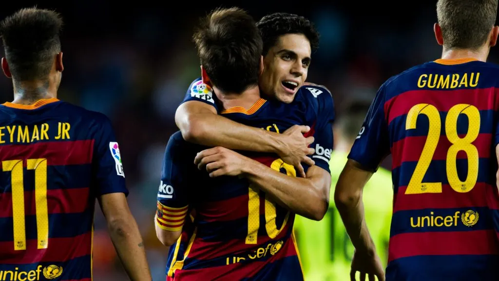 Lionel Messi of FC Barcelona celebrates with Marc Bartra after scoring his team’s fourth goal against Levante UD. (Alex Caparros/Getty Images)