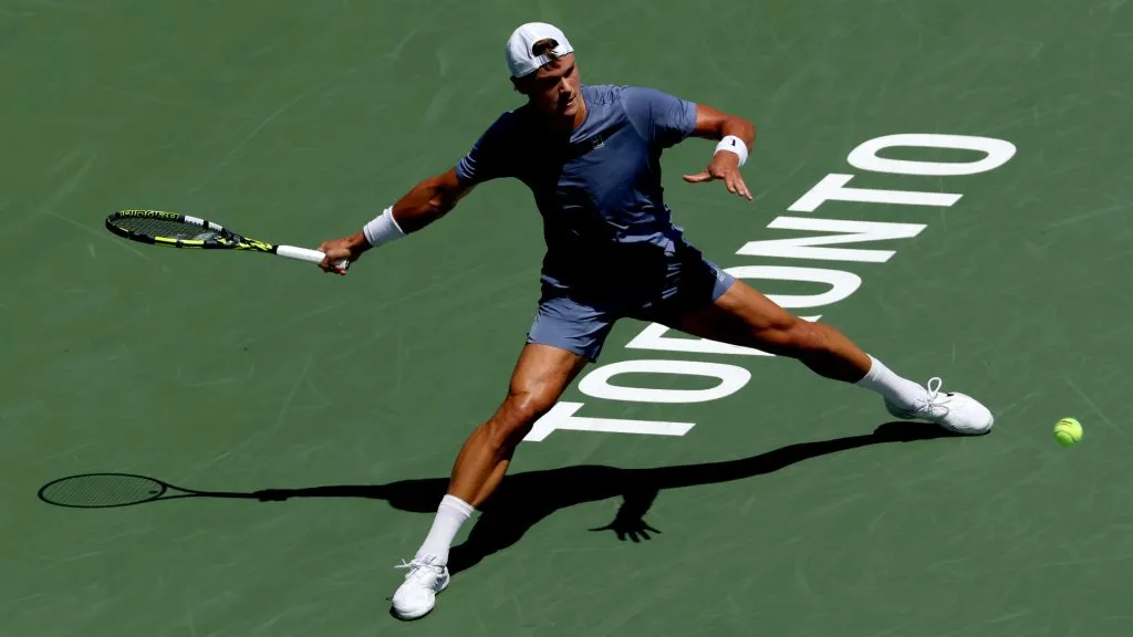Holger Rune of Denmark stretches for a ball against Giovanni Mpetshi Perricard of France during the National Bank Open in Toronto. (Matthew Stockman/Getty Images)