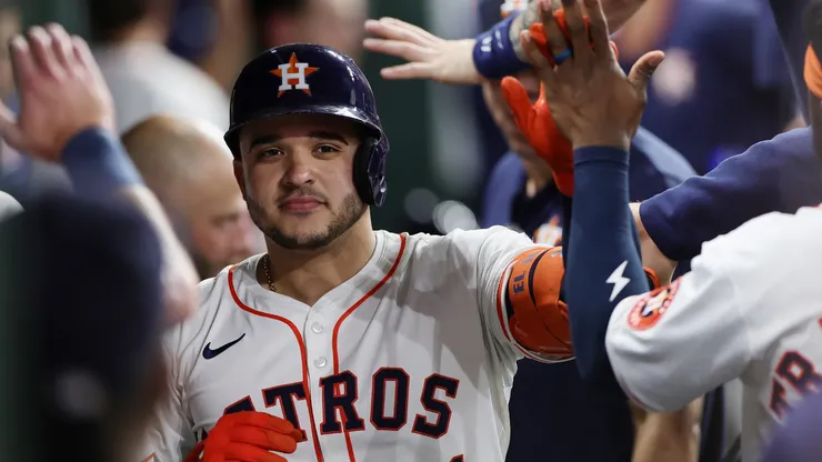 Yainer Diaz #21 of the Houston Astros celebrates with teammates after hitting a solo home run.