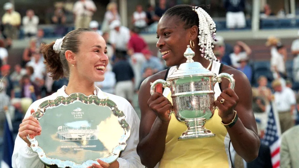 Serena Williams of the USA and Martina Hingis of Switzerland smile and pose with their trophies after their match in the US Open final. (Jamie Squire/Allsport/Getty Images)