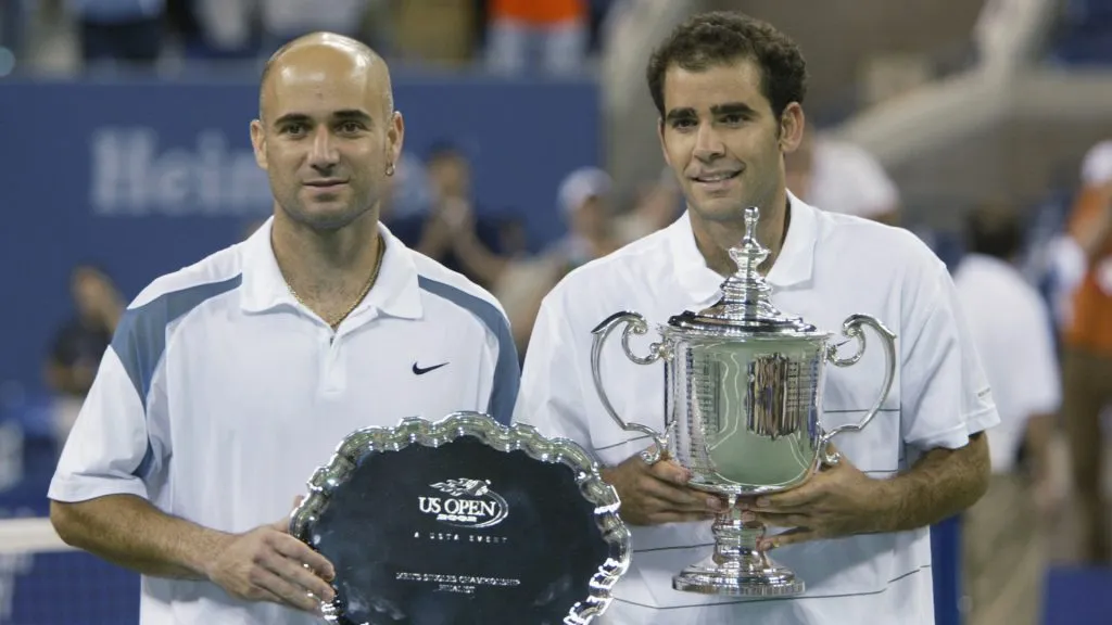 Andre Agassi and Pete Sampras pose with their trophies after the 2002 US Open final. (Gary Prior/Getty Images)