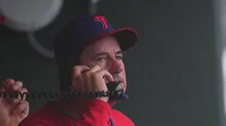 Rob Thomson #59 of the Philadelphia Phillies talks on the phone during a delay in the game against the Los Angeles Angels at Citizens Bank Park on July 20, 2025 in Philadelphia, Pennsylvania.