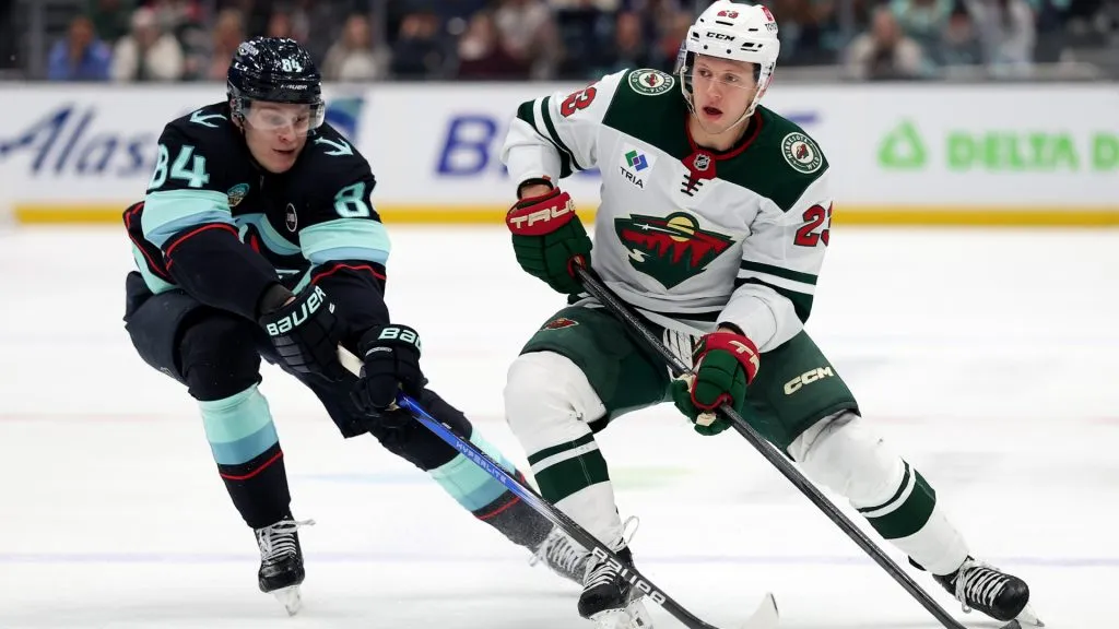Kaapo Kakko #84 of the Seattle Kraken back checks against Marco Rossi #23 of the Minnesota Wild during the first period at Climate Pledge Arena on March 04, 2025 in Seattle, Washington. (Photo by Steph Chambers/Getty Images)