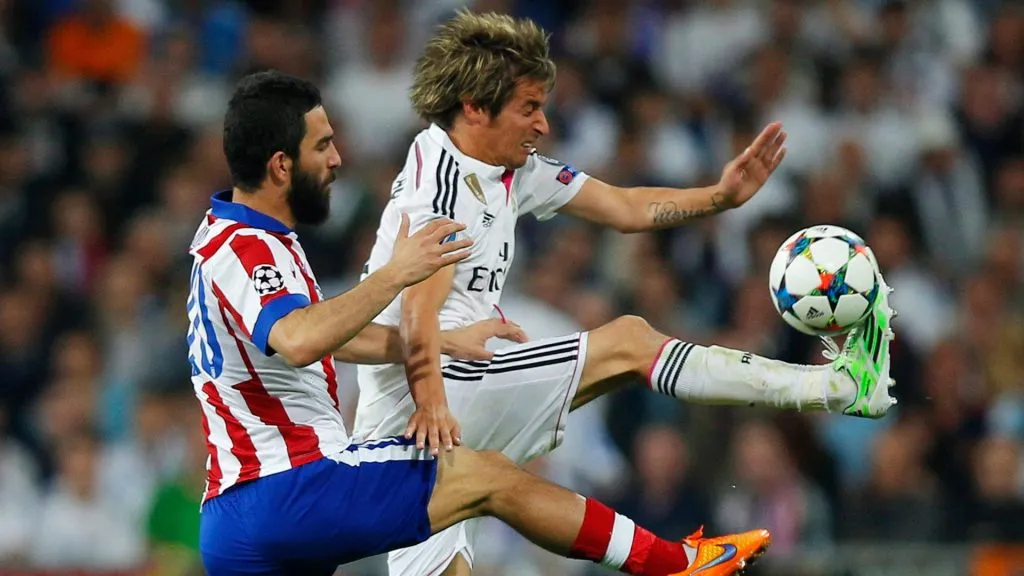 Fabio Coentrao of Real Madrid CF and Arda Turan of Atletico Madrid during the UEFA Champions League quarter-final second leg match between Real Madrid CF and Club Atletico de Madrid.