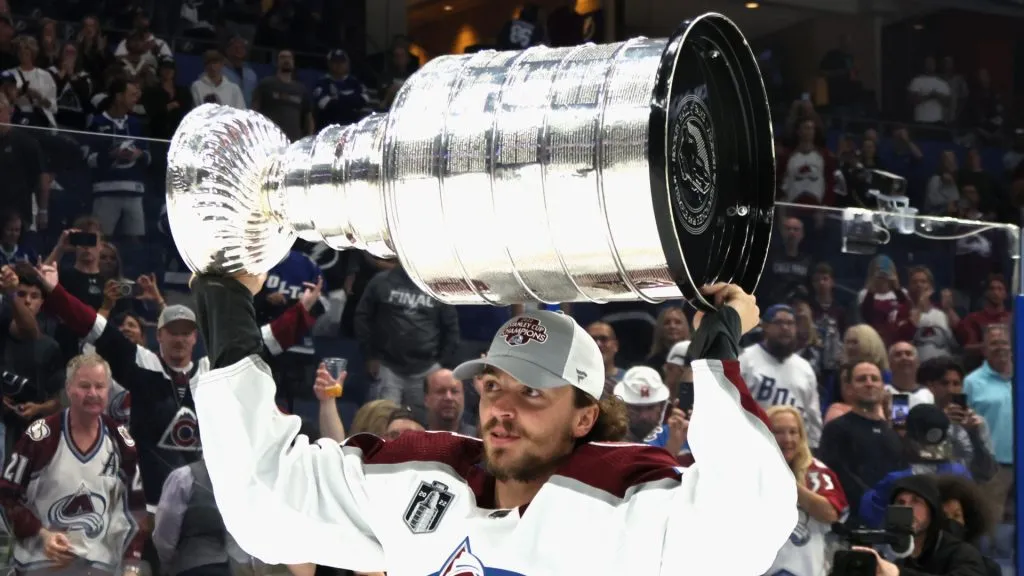 Samuel Girard #49 of the Colorado Avalanche carries the Stanley Cup following the series winning victory over the Tampa Bay Lightning in Game Six of the 2022 NHL Stanley Cup Final at Amalie Arena on June 26, 2022 in Tampa, Florida.