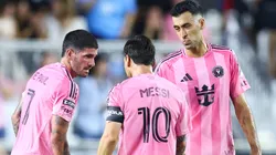 Rodrigo de Paul #7, Lionel Messi #10 and Sergio Busquets #5 of Inter Miami speak on the field in the second half during a Leagues Cup game.