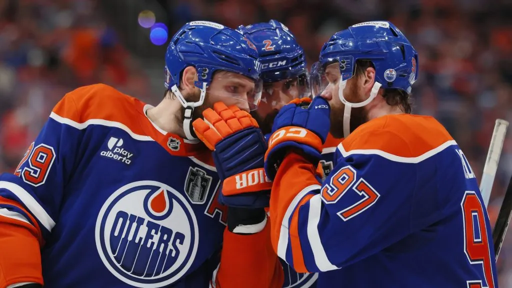 Leon Draisaitl #29, Evan Bouchard #2 and Connor McDavid #97 of the Edmonton Oilers confer during the game against the Florida Panthers during Game Five of the 2025 NHL Stanley Cup Final at Rogers Place on June 14, 2025 in Edmonton, Alberta, Canada. (Photo by Bruce Bennett/Getty Images)