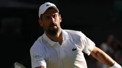 Novak Djokovic of Serbia plays a forehand volley against Jannik Sinner of Italy.
