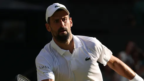 Novak Djokovic of Serbia plays a forehand volley against Jannik Sinner of Italy.
