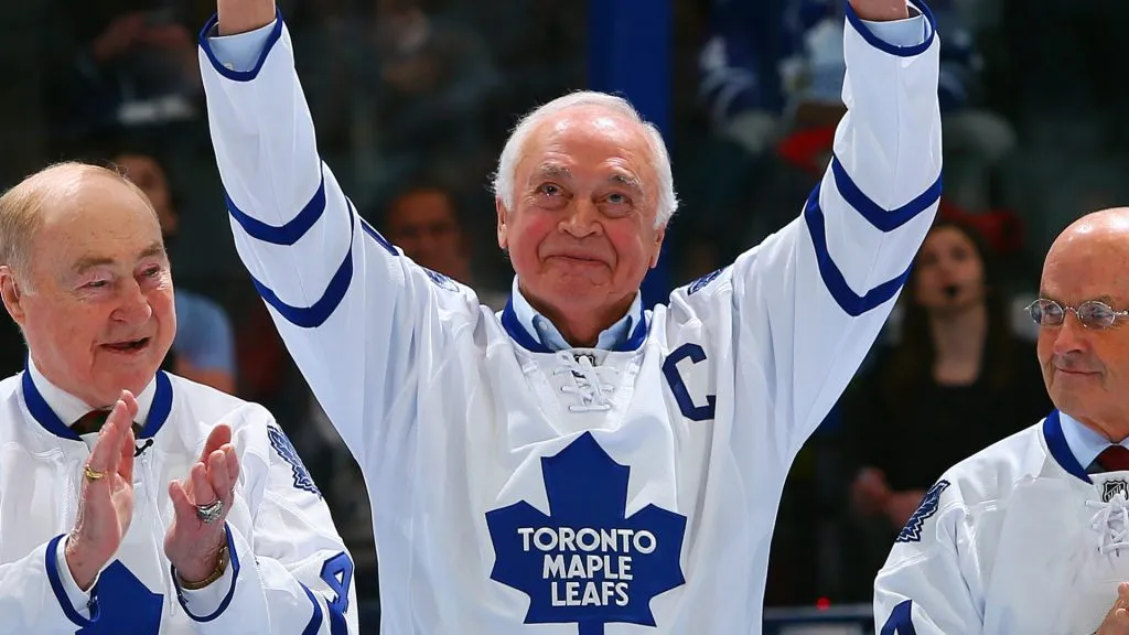 George Armstrong waves to the crowd beside Red Kelly and David Keon during a ceremony commemorating the 50th anniversary of the Leafs 64′ Stancley Cup in 2013. (Source: Abelimages/Getty Images)