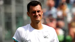Bernard Tomic of Australia reacts in his Men's Singles first round match against Jo-Wilfred Tsonga of France during 2019 Wimbledon.