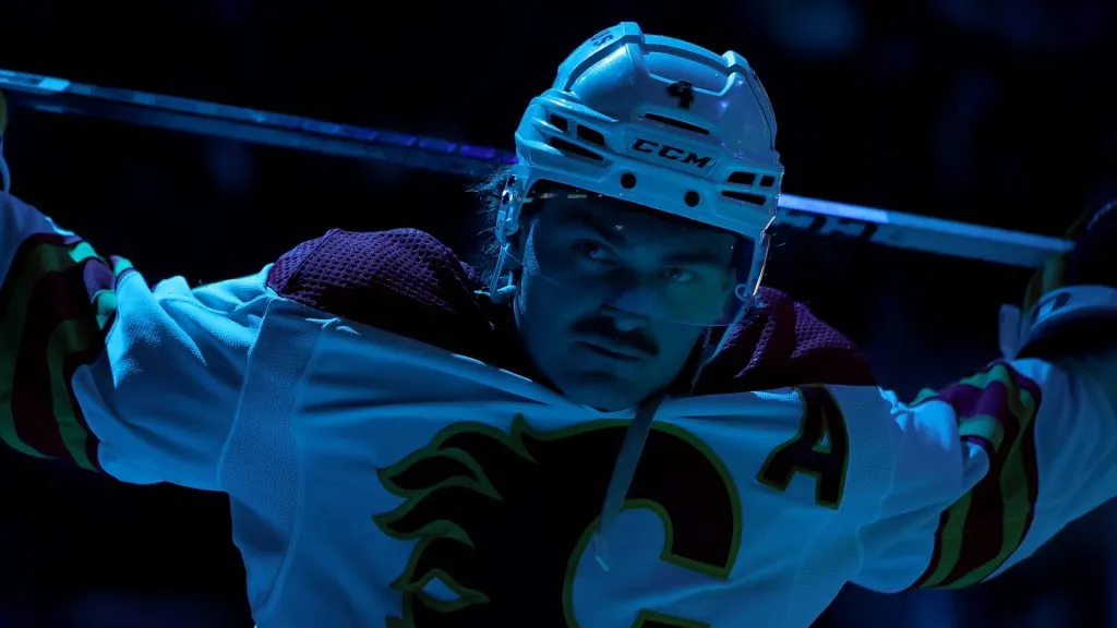 Rasmus Andersson #4 of the Calgary Flames stretches before the second period against the Seattle Kraken at Climate Pledge Arena on November 04, 2023 in Seattle, Washington.