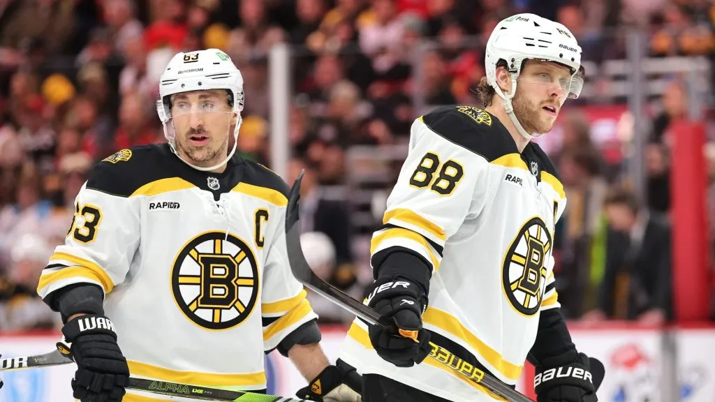Brad Marchand #63 and David Pastrnak #88 of the Boston Bruins look on against the Chicago Blackhawks during the third period at the United Center on December 04, 2024 in Chicago, Illinois.