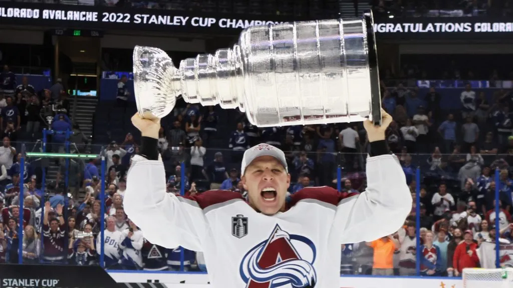 Jack Johnson #3 of the Colorado Avalanche carries the Stanley Cup following the series winning victory over the Tampa Bay Lightning in Game Six of the 2022 NHL Stanley Cup Final at Amalie Arena on June 26, 2022 in Tampa, Florida.