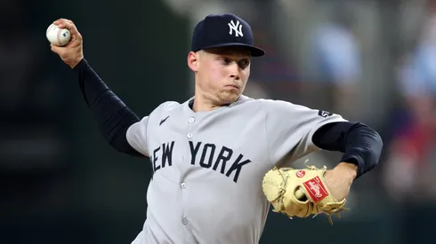Will Warren #98 of the New York Yankees throws a pitch during the fourth inning against the Texas Rangers at Globe Life Field on August 05, 2025 in Arlington, Texas.