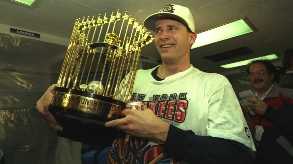 Pitcher Andy Pettitte of the New York Yankees celebrates with the World Series Trophy after Game Six of the World Series against the Atlanta Braves in 1996. (Source: Getty Images)