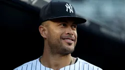 Giancarlo Stanton #27 of the New York Yankees looks on from the dugout before the game against the Minnesota Twins.