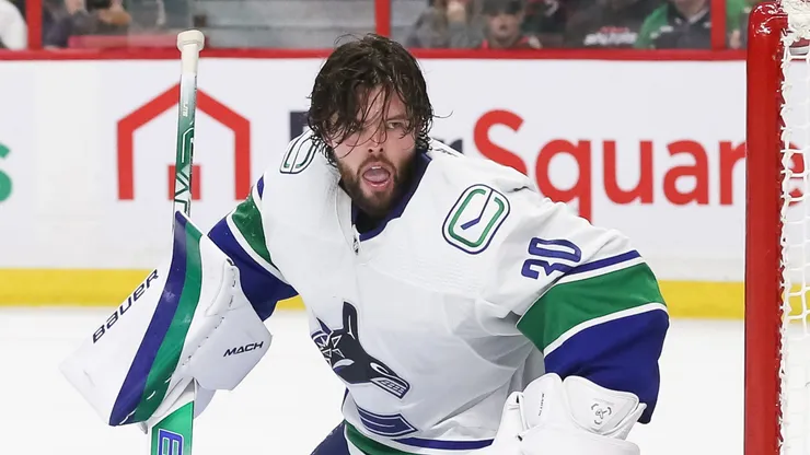 Spencer Martin #30 of the Vancouver Canucks tracks the puck after a shot knocks his mask off in the second period of the game against the Ottawa Senators at Canadian Tire Centre on November 08, 2022 in Ottawa, Ontario, Canada.