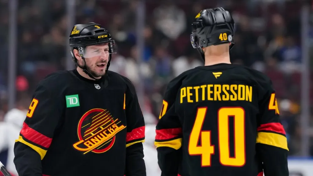 J.T. Miller #9 of the Vancouver Canucks skates past Elias Pettersson #40 before the second period of their NHL game against the Washington Capitals at Rogers Arena on January 25, 2025 in Vancouver, British Columbia, Canada. 
