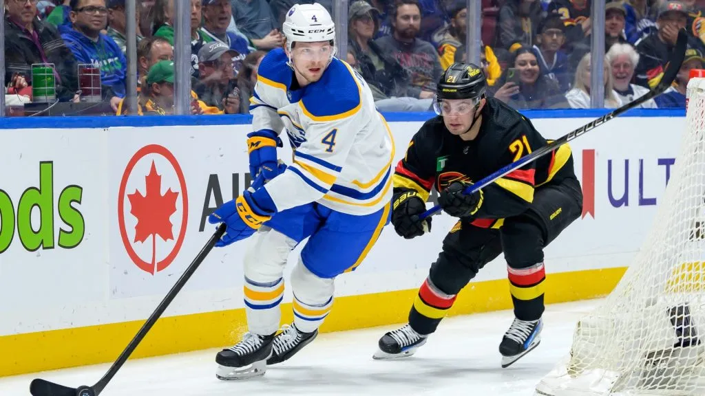 Bowen Byram #4 of the Buffalo Sabres is pursued by Nils Hoglander #21 of the Vancouver Canucks during the first period of their NHL game at Rogers Arena on March 19, 2024 in Vancouver, British Columbia, Canada. (Photo by Derek Cain/Getty Images)