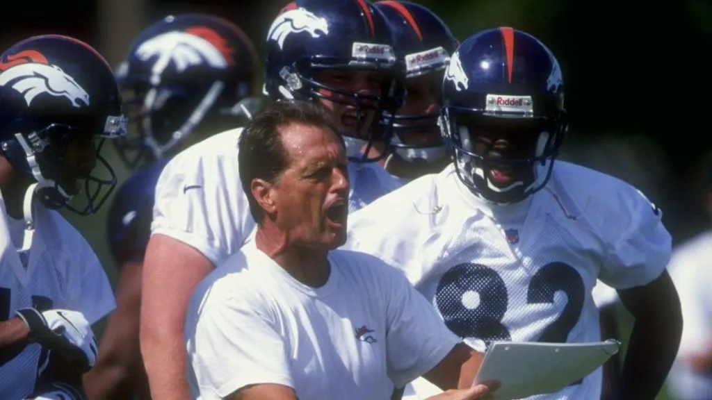 Offensive line coach Alex Gibbs of the Denver Broncos discusses a play during the Broncos training camp at the University of Northern Colorado in 1998. (Source: Getty Images)