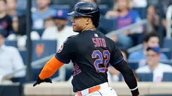 Juan Soto #22 of the New York Mets follows through on his first inning base hit against the Atlanta Braves.