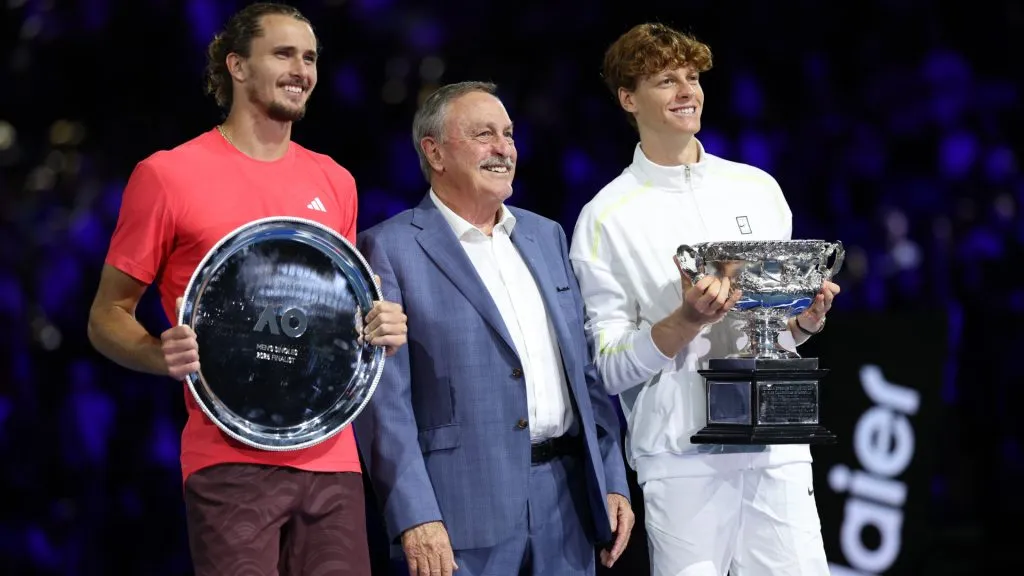 Winner Jannik Sinner of Italy and runner-up Alexander Zverev of Germany pose with John Newcombe at the 2025 Australian Open trophy presentation. (Clive Brunskill/Getty Images)