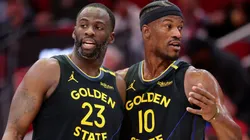 Draymond Green #23 and Jimmy Butler #10 of the Golden State Warriors speak on the court.