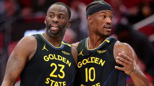 Draymond Green #23 and Jimmy Butler #10 of the Golden State Warriors speak on the court.