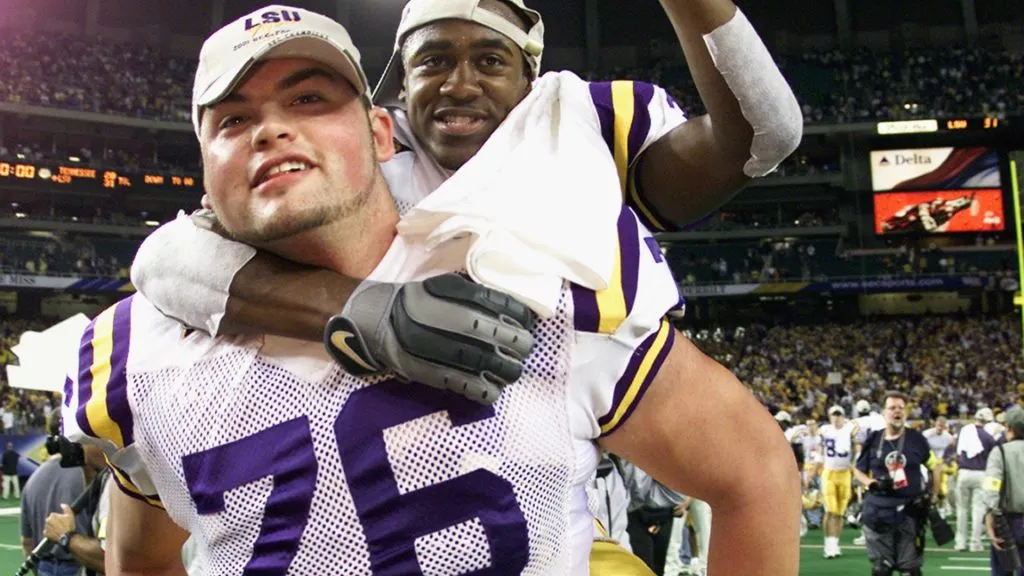 Andrew Whitworth #76 of the LSU Tigers gives a teammate a piggyback ride after winning the Southeastern Conference Championship Game in 2001. (Source: Jamie Squire/Getty Images)