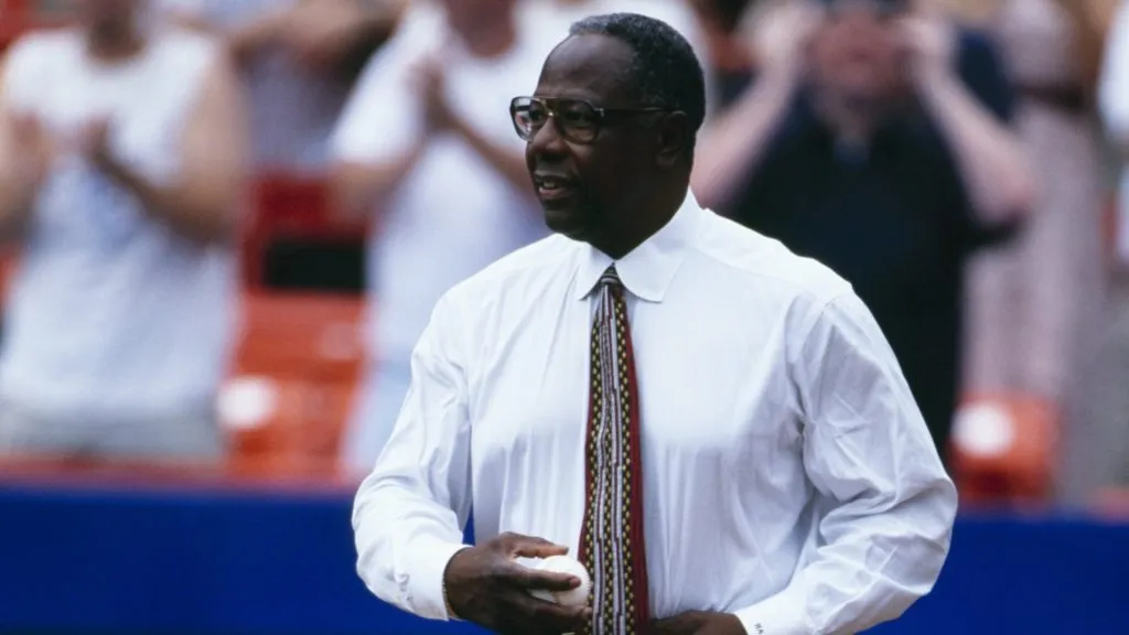 Hank Aaron walks on the field before the Atlanta Braves game against the New York Mets at Shea Stadium on July 3, 1999. (Source: Jamie Squire/Getty Images)
