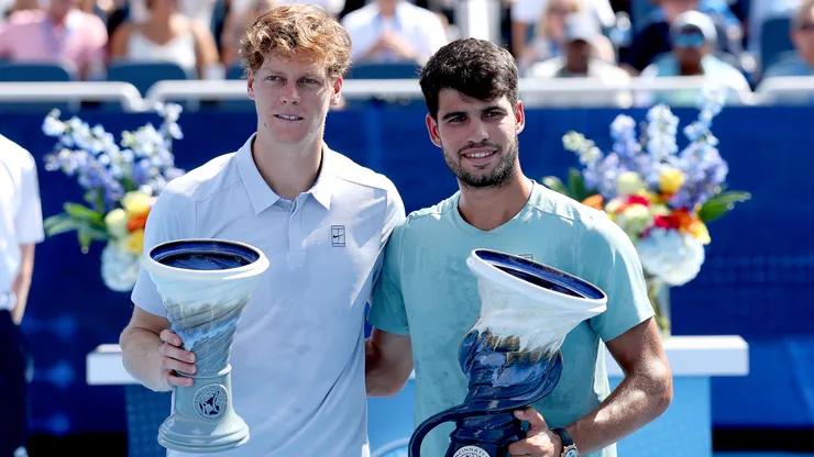 Jannik Sinner of Italy and Carlos Alcaraz of Spain pose with their Rookwood Cups after the Cincinnati Open final.