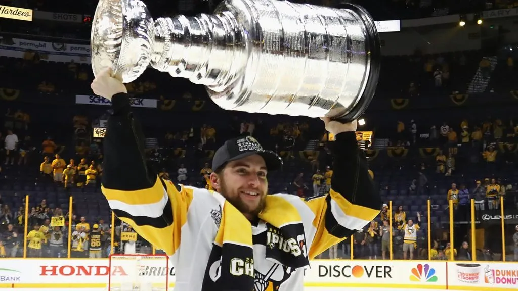 Conor Sheary of the Pittsburgh Penguins hoists the Stanley Cup at Bridgestone Arena in Nashville, Tennessee.